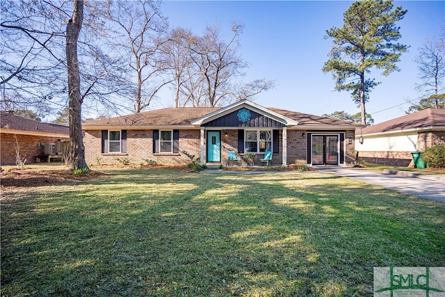 view of front of property with a front yard and brick siding