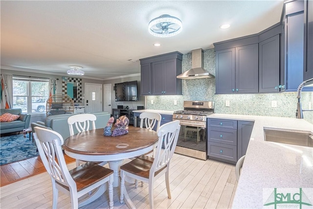 dining space featuring recessed lighting, light wood-type flooring, and ornamental molding