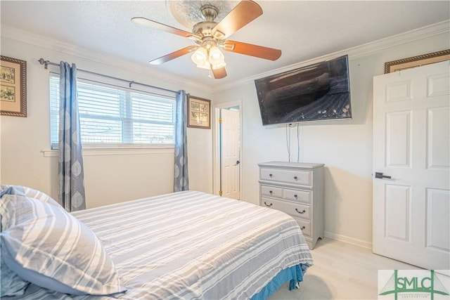 bedroom featuring light wood-style flooring, baseboards, a ceiling fan, and ornamental molding