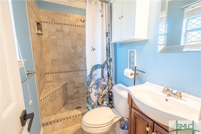 full bathroom featuring vanity, toilet, and a tile shower