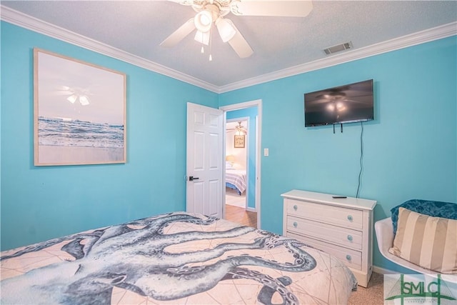 carpeted bedroom with visible vents, a ceiling fan, and crown molding