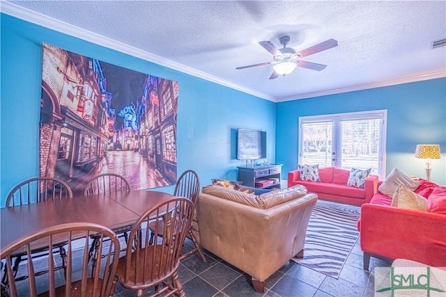 living room featuring a textured ceiling, a ceiling fan, visible vents, and ornamental molding