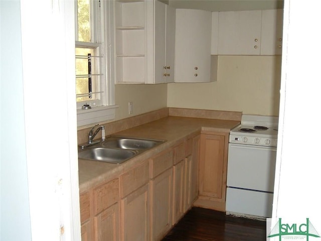 kitchen with a sink, dark wood-style floors, light countertops, and electric stove