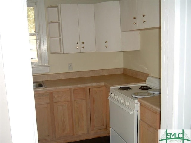 kitchen featuring light countertops and white electric stove