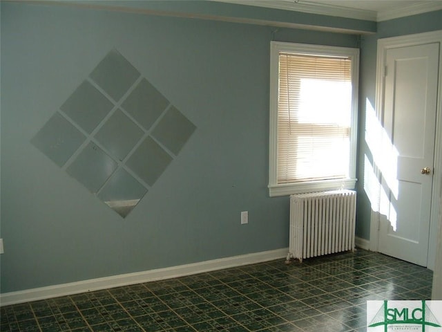 empty room featuring baseboards and radiator