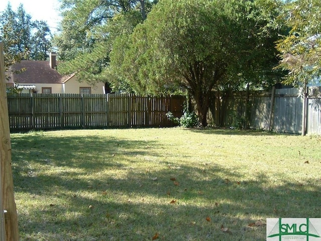 view of yard with a fenced backyard