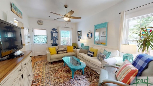 living room featuring ceiling fan and wood finished floors