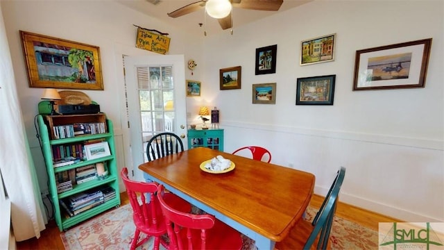 dining space featuring a ceiling fan and wood finished floors