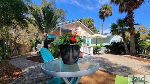 view of patio with outdoor dining space and fence