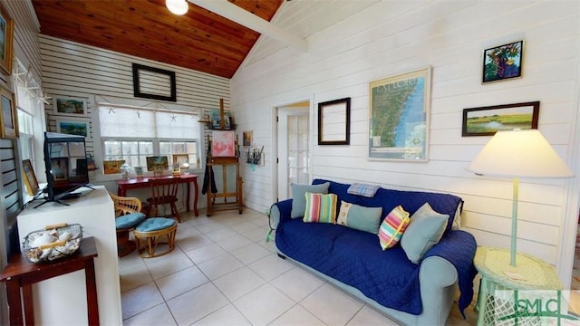 tiled living area featuring lofted ceiling with beams and wood ceiling