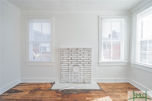 interior details with baseboards, a textured ceiling, and wood finished floors