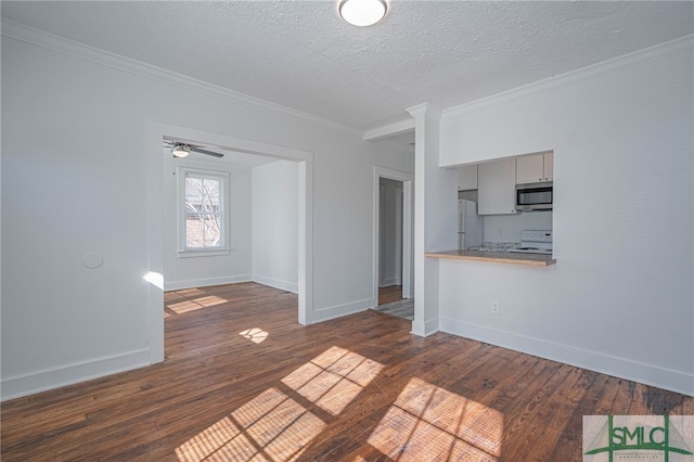 unfurnished living room with dark wood finished floors, a textured ceiling, baseboards, and ornamental molding