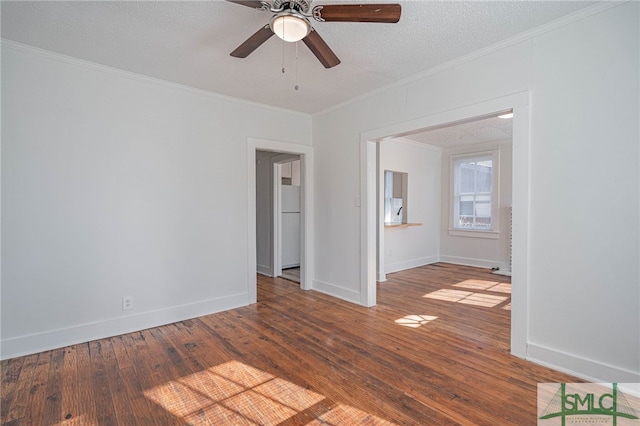 spare room featuring baseboards, ornamental molding, hardwood / wood-style flooring, a textured ceiling, and a ceiling fan