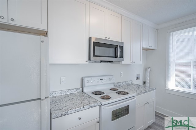 kitchen featuring white appliances, baseboards, light wood-style flooring, white cabinetry, and crown molding