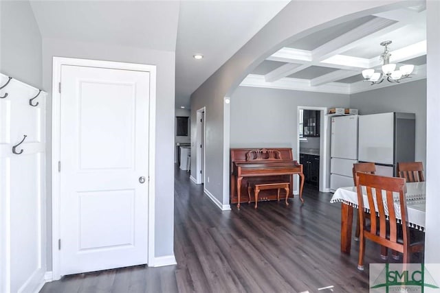 dining room with dark wood-style floors, baseboards, coffered ceiling, arched walkways, and beamed ceiling