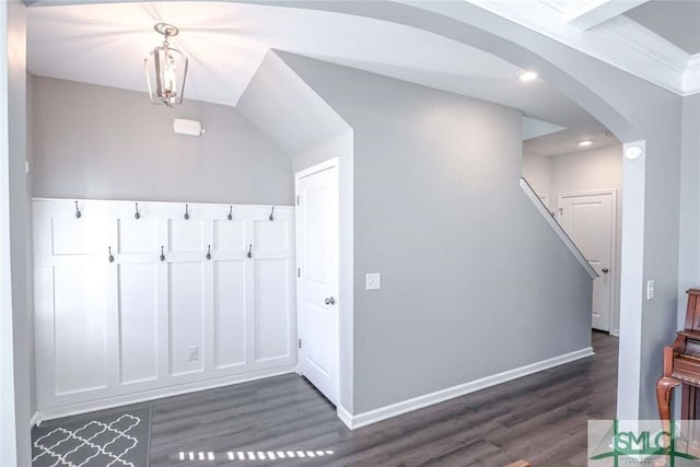 bonus room with dark wood finished floors, stairs, baseboards, and arched walkways