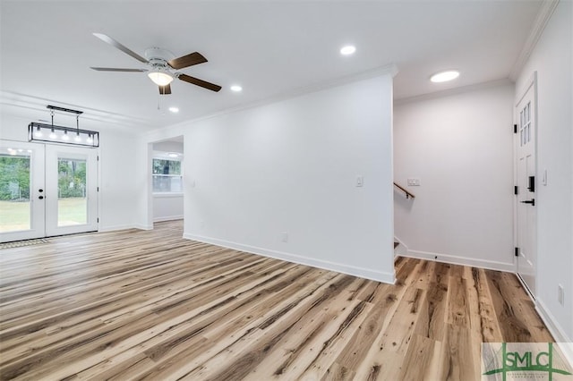 empty room with recessed lighting, crown molding, light wood-type flooring, and baseboards