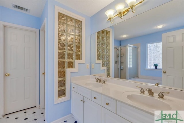 bathroom featuring a bath, visible vents, a shower stall, and a sink