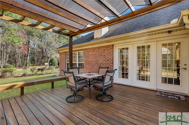 wooden deck featuring french doors, outdoor dining space, and a pergola