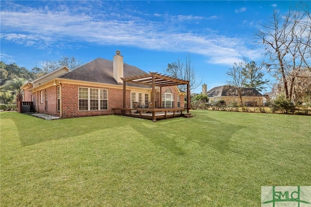 rear view of property with brick siding, a chimney, a lawn, and a pergola