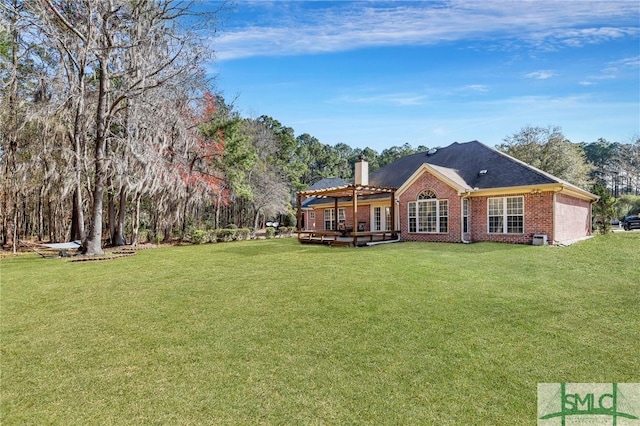 back of house with a wooden deck, a chimney, a garage, a lawn, and brick siding