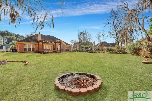 view of yard featuring an outdoor fire pit and a pergola