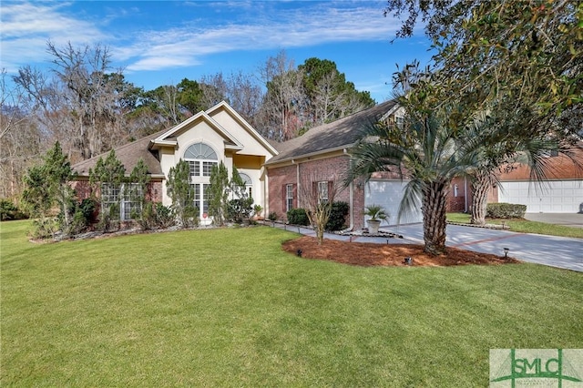 view of front facade featuring a front yard, driveway, an attached garage, stucco siding, and brick siding