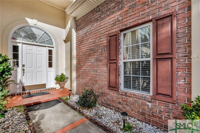 entrance to property with brick siding