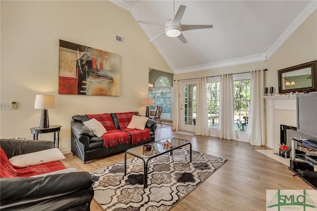 living area featuring visible vents, crown molding, a ceiling fan, and wood finished floors