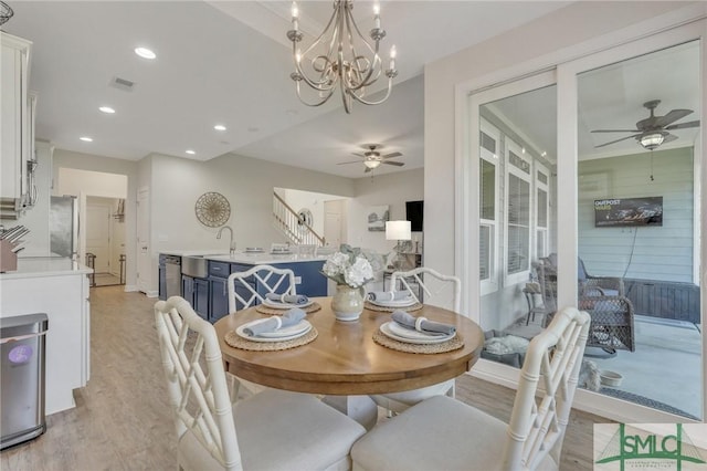 dining room with recessed lighting, visible vents, light wood-style flooring, and ceiling fan with notable chandelier