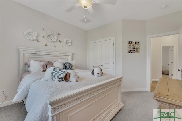 bedroom featuring a closet, light colored carpet, baseboards, and ceiling fan