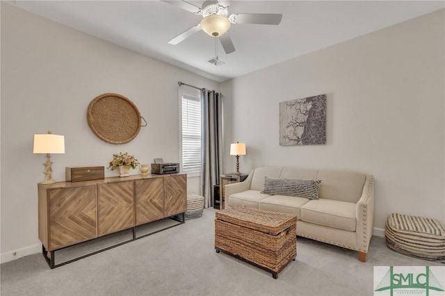 sitting room with visible vents, baseboards, light colored carpet, and a ceiling fan