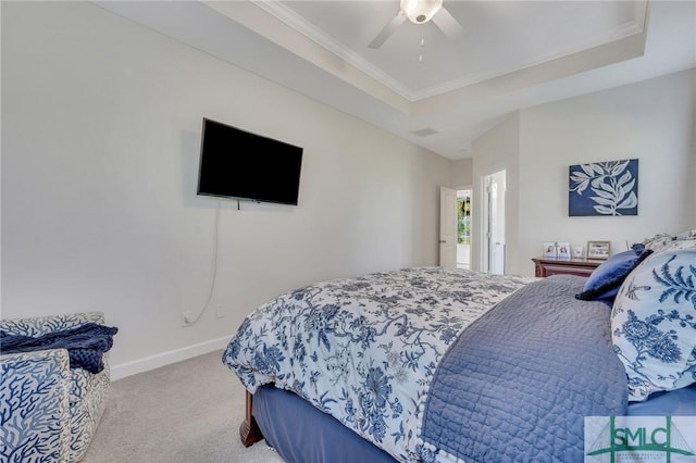 bedroom featuring baseboards, a raised ceiling, carpet floors, and ornamental molding