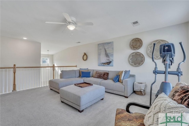 carpeted living area featuring visible vents and a ceiling fan