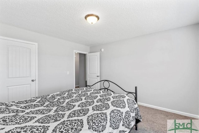 carpeted bedroom with a textured ceiling and baseboards