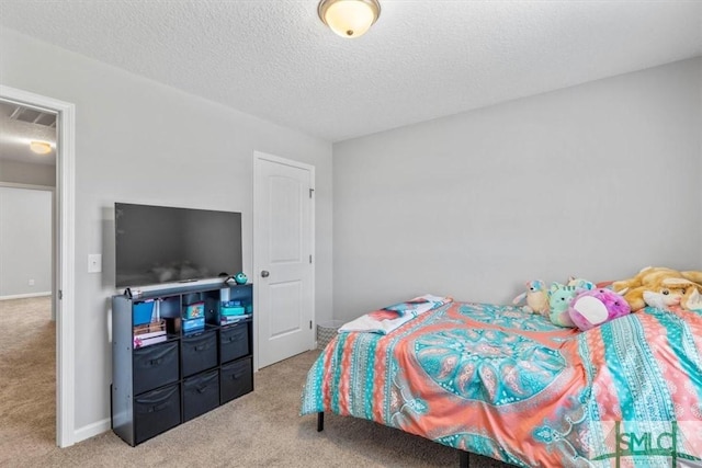 bedroom featuring visible vents, baseboards, light colored carpet, and a textured ceiling