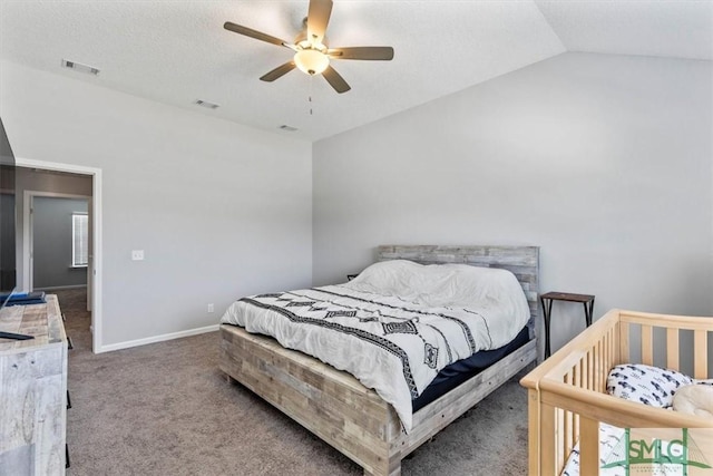 bedroom with visible vents, lofted ceiling, baseboards, and carpet flooring