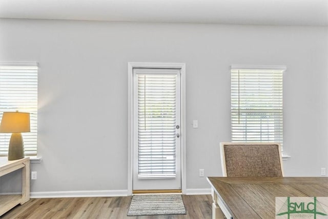 interior space with baseboards and wood finished floors