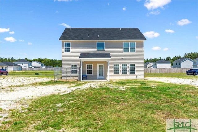 view of front of home featuring a front yard and fence