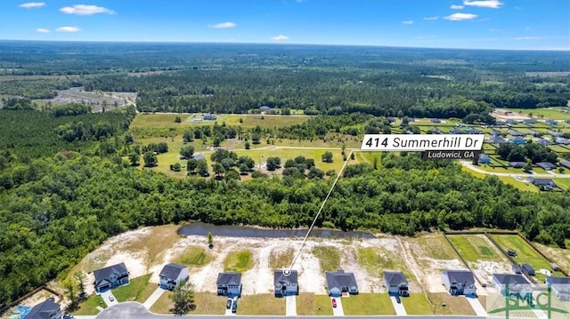 drone / aerial view with a view of trees and a water view