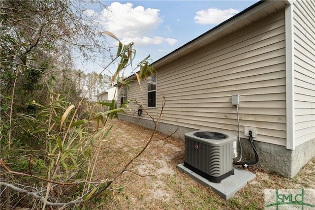 view of home's exterior with central AC unit