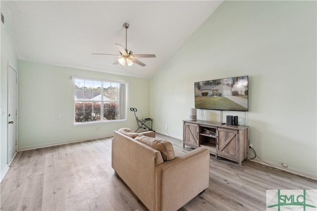 living area with light wood-type flooring, ceiling fan, and vaulted ceiling