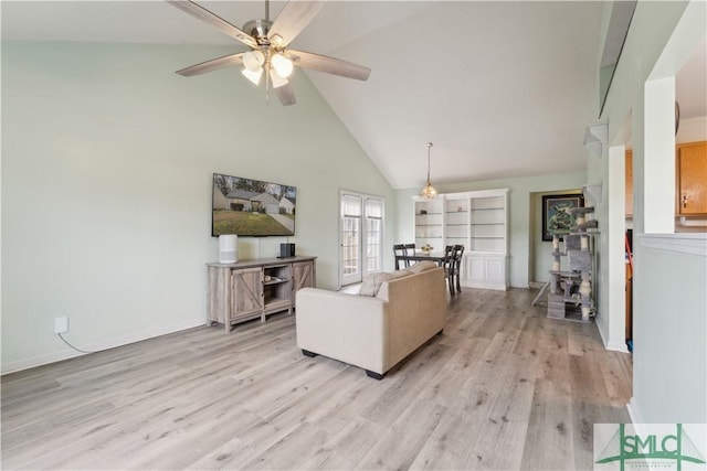 living area featuring baseboards, light wood-style flooring, high vaulted ceiling, and ceiling fan