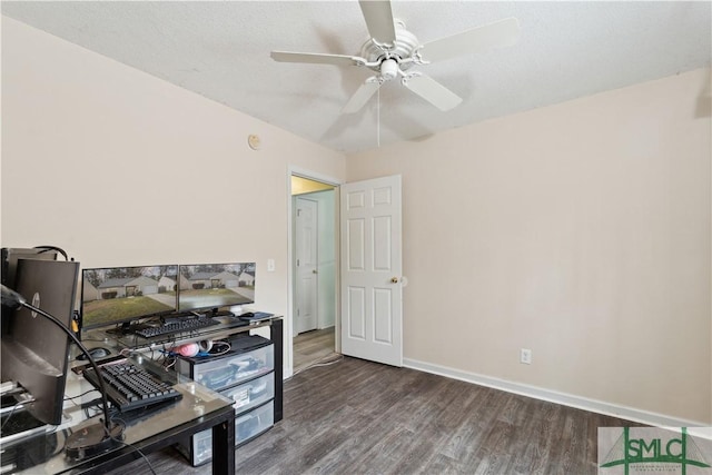 office featuring ceiling fan, a textured ceiling, baseboards, and wood finished floors