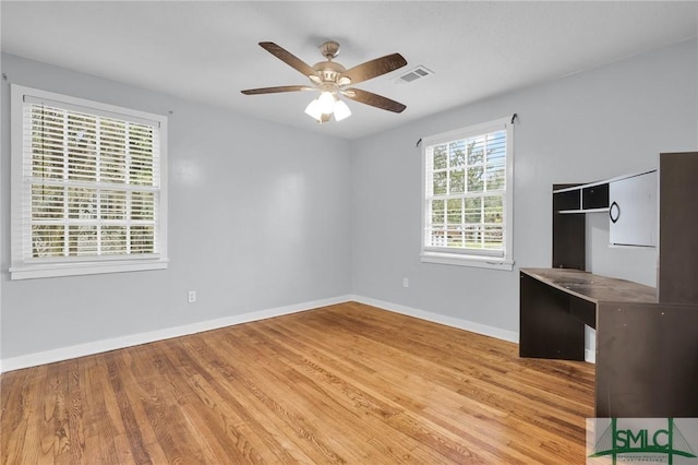 spare room with visible vents, baseboards, ceiling fan, and light wood finished floors