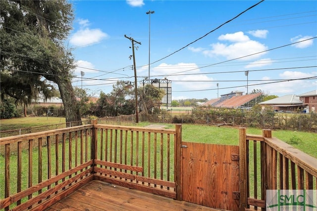 deck with a yard and fence
