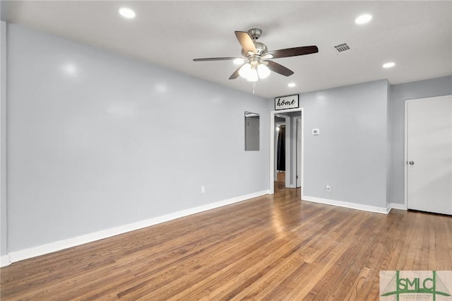 unfurnished room with wood finished floors, visible vents, baseboards, recessed lighting, and ceiling fan