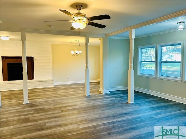 interior space featuring baseboards, crown molding, a ceiling fan, and wood finished floors