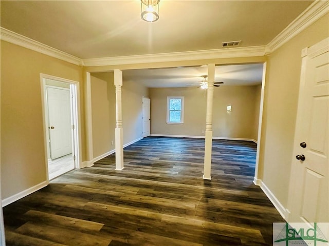 spare room with dark wood-type flooring, baseboards, visible vents, and ornamental molding