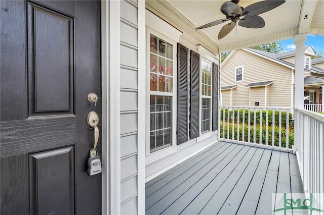 deck featuring covered porch and ceiling fan